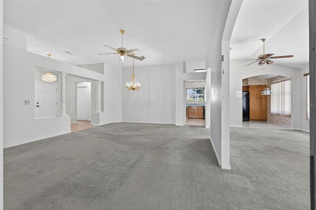 206 Palermo Pl, Lady Lake, FL 32159 - unfurnished living room featuring ceiling fan, light colored carpet, a chandelier, a textured ceiling, and arched walkways
