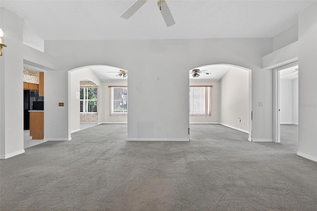 206 Palermo Pl, Lady Lake, FL 32159 - unfurnished living room with a ceiling fan, arched walkways, and carpet floors