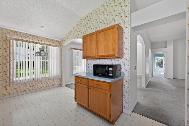 206 Palermo Pl, Lady Lake, FL 32159 - kitchen featuring black microwave, lofted ceiling, wallpapered walls, arched walkways, and light carpet