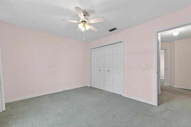206 Palermo Pl, Lady Lake, FL 32159 - unfurnished bedroom featuring carpet flooring, a textured ceiling, a closet, and a ceiling fan