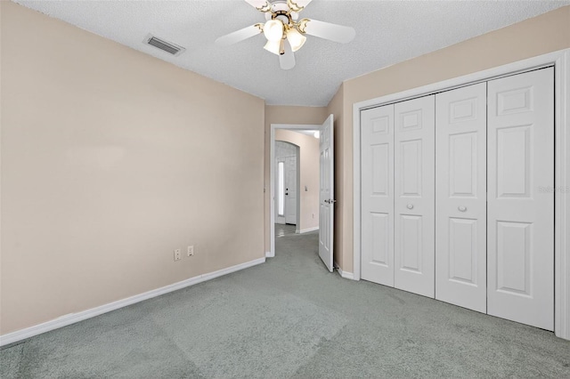 206 Palermo Pl, Lady Lake, FL 32159 - unfurnished bedroom featuring carpet flooring, a closet, a ceiling fan, and a textured ceiling