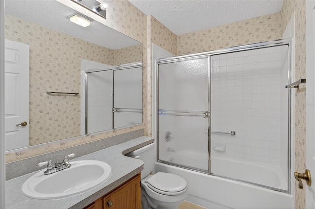 206 Palermo Pl, Lady Lake, FL 32159 - full bath featuring wallpapered walls, a textured ceiling, vanity, and shower / bath combination with glass door