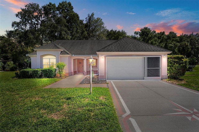 206 Palermo Pl, Lady Lake, FL 32159 - ranch-style home with concrete driveway, stucco siding, an attached garage, a lawn, and a shingled roof