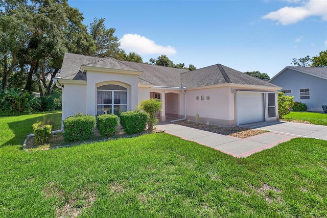 206 Palermo Pl, Lady Lake, FL 32159 - view of front of property with a garage, a front lawn, stucco siding, concrete driveway, and a shingled roof