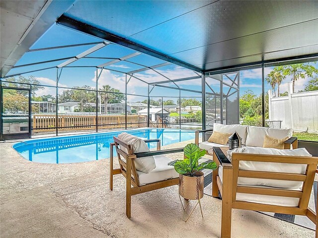 1611 Canal, Tavares, FL 32778 - swimming pool featuring an outdoor hangout area, a patio area, a fenced backyard, and glass enclosure