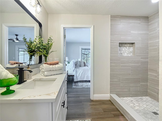 1611 Canal, Tavares, FL 32778 - ensuite bathroom with vanity, wood finished floors, tiled shower, a ceiling fan, and a textured ceiling