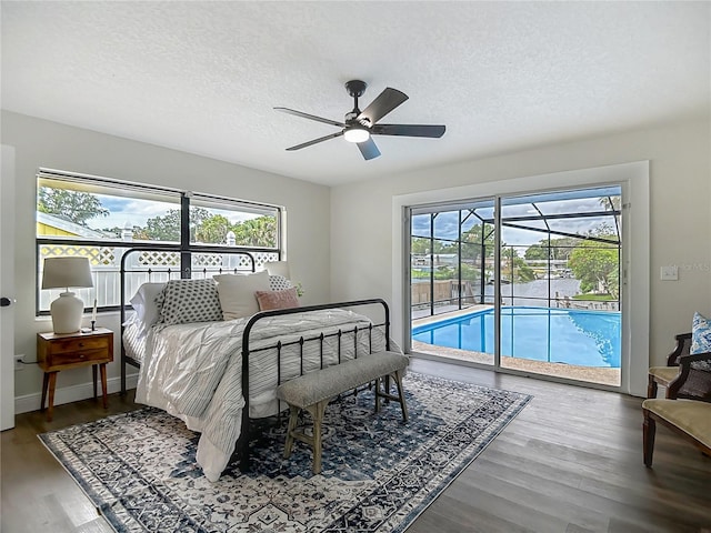1611 Canal, Tavares, FL 32778 - bedroom featuring a sunroom, access to exterior, a textured ceiling, wood finished floors, and a ceiling fan