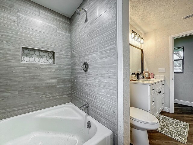 1611 Canal, Tavares, FL 32778 - bathroom with vanity, wood finished floors, tub / shower combination, a textured wall, and a textured ceiling