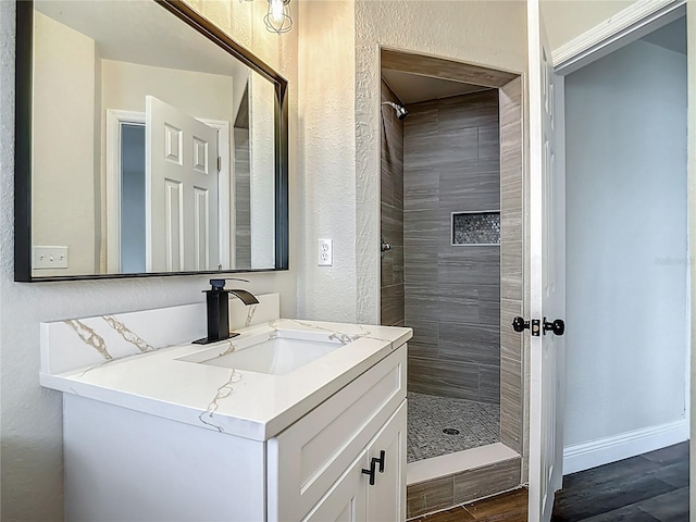 1611 Canal, Tavares, FL 32778 - full bath with a shower stall, vanity, a textured wall, and wood finished floors