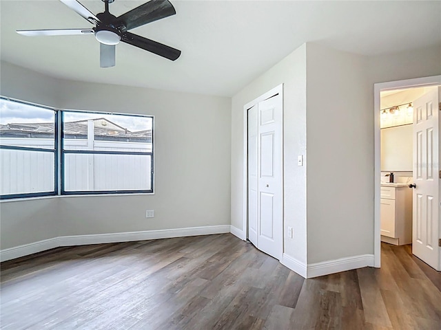 1611 Canal, Tavares, FL 32778 - unfurnished bedroom featuring wood finished floors, a closet, and a ceiling fan