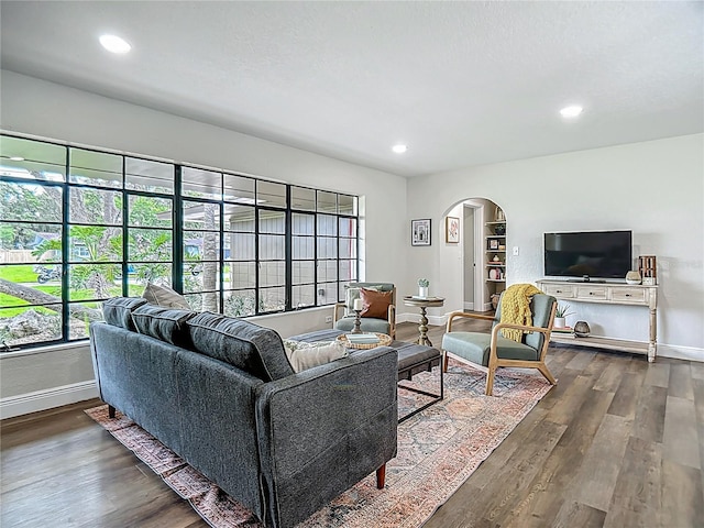 1611 Canal, Tavares, FL 32778 - living room with arched walkways, dark wood-style flooring, and recessed lighting