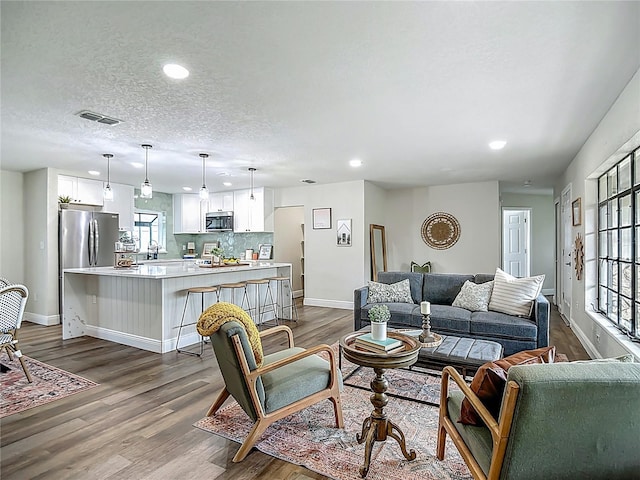 1611 Canal, Tavares, FL 32778 - living room with recessed lighting, dark wood finished floors, and a textured ceiling