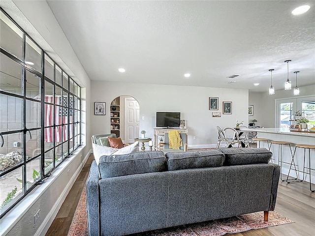 1611 Canal, Tavares, FL 32778 - living room featuring arched walkways, wood finished floors, recessed lighting, and a textured ceiling