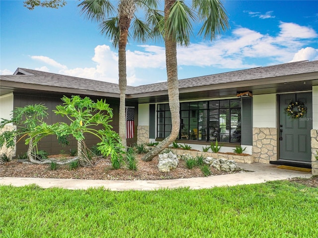 1611 Canal, Tavares, FL 32778 - view of front of house featuring stone siding and a front lawn