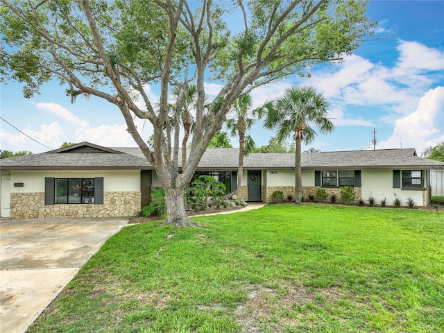 1611 Canal, Tavares, FL 32778 - single story home featuring stone siding, driveway, and a front lawn