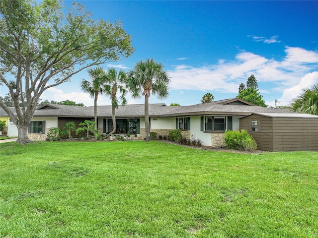 1611 Canal, Tavares, FL 32778 - view of front of home with stone siding, a front yard, and stucco siding