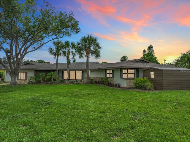 1611 Canal, Tavares, FL 32778 - rear view of property featuring stone siding, a yard, and stucco siding