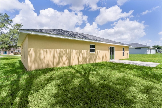 14631 SE 95th Ct, Summerfield, FL 34491 - rear view of house with stucco siding and a yard