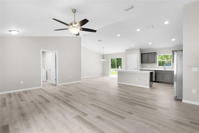 14631 SE 95th Ct, Summerfield, FL 34491 - unfurnished living room featuring separate washer and dryer, lofted ceiling, ceiling fan, light wood-style flooring, and recessed lighting