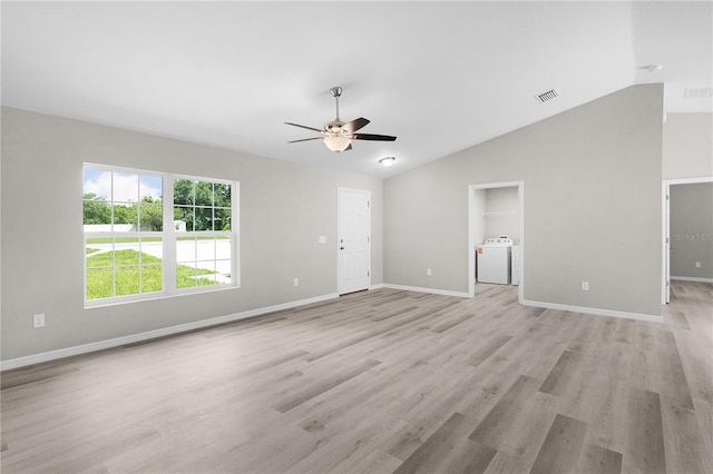 14631 SE 95th Ct, Summerfield, FL 34491 - unfurnished living room with washer / dryer, ceiling fan, vaulted ceiling, and light wood-style flooring