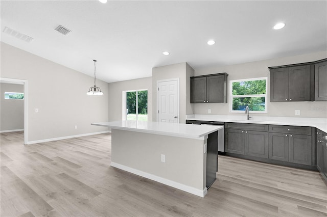 14631 SE 95th Ct, Summerfield, FL 34491 - kitchen featuring plenty of natural light, lofted ceiling, light countertops, light wood-style floors, and a center island