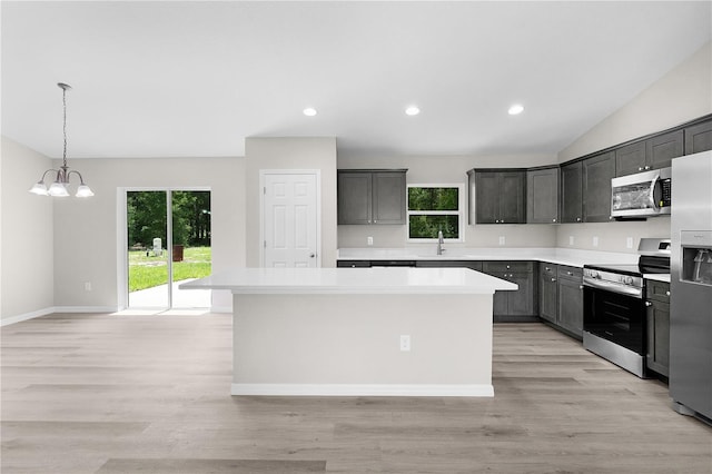 14631 SE 95th Ct, Summerfield, FL 34491 - kitchen with appliances with stainless steel finishes, a chandelier, a center island, light countertops, and plenty of natural light