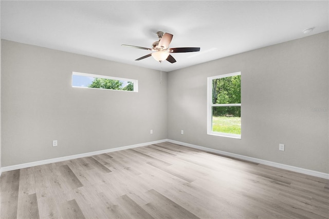 14631 SE 95th Ct, Summerfield, FL 34491 - empty room with healthy amount of natural light, ceiling fan, and light wood finished floors