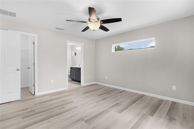 14631 SE 95th Ct, Summerfield, FL 34491 - unfurnished bedroom with a walk in closet, light wood-style flooring, connected bathroom, ceiling fan, and a closet