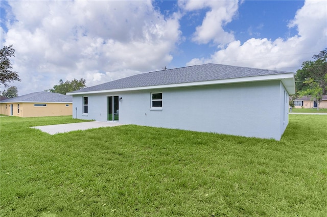 14611 SE 95th Ct, Summerfield, FL 34491 - back of property featuring stucco siding, a patio area, a lawn, and roof with shingles