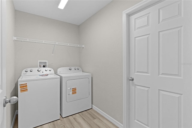 14611 SE 95th Ct, Summerfield, FL 34491 - washroom with washer and dryer and light wood finished floors