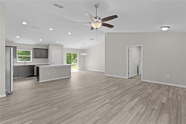 14611 SE 95th Ct, Summerfield, FL 34491 - unfurnished living room with healthy amount of natural light, a ceiling fan, vaulted ceiling, recessed lighting, and a chandelier