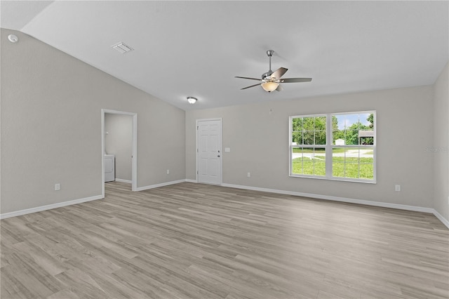 14611 SE 95th Ct, Summerfield, FL 34491 - spare room with vaulted ceiling, washer / dryer, a ceiling fan, and light wood-style flooring