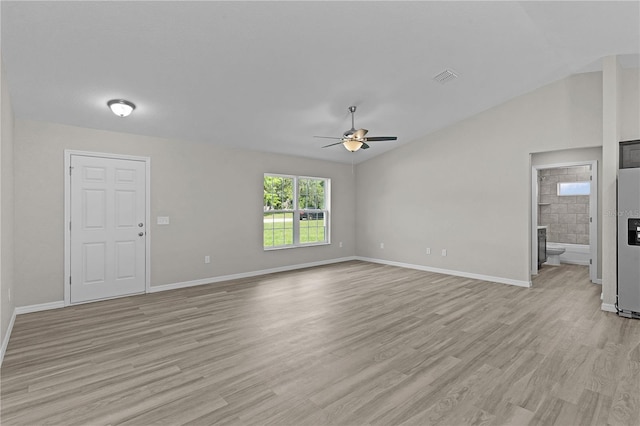 14611 SE 95th Ct, Summerfield, FL 34491 - unfurnished living room featuring a ceiling fan, light wood-style floors, and vaulted ceiling