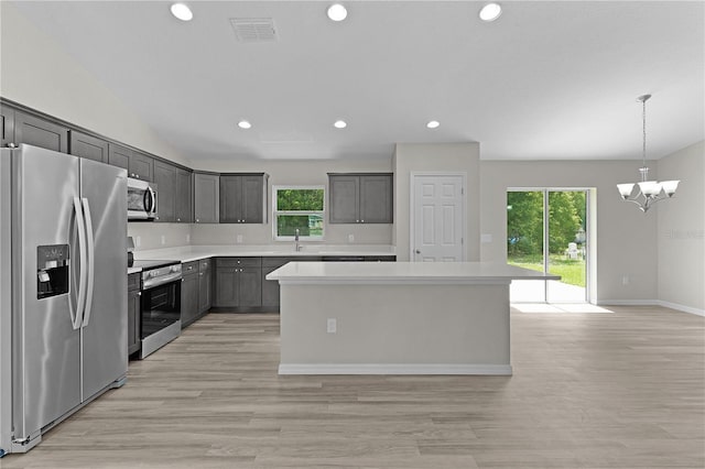 14611 SE 95th Ct, Summerfield, FL 34491 - kitchen with appliances with stainless steel finishes, plenty of natural light, recessed lighting, a center island, and light wood finished floors