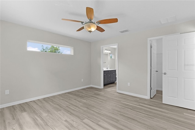 14611 SE 95th Ct, Summerfield, FL 34491 - unfurnished bedroom with a walk in closet, light wood finished floors, ensuite bath, and a closet