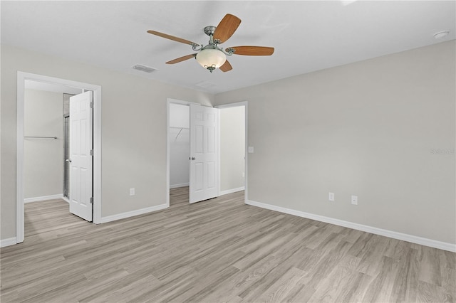 14611 SE 95th Ct, Summerfield, FL 34491 - unfurnished bedroom featuring light wood-type flooring, a spacious closet, a closet, and ceiling fan