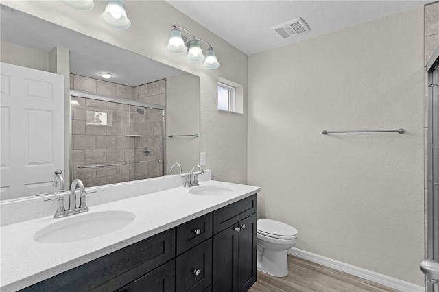 14611 SE 95th Ct, Summerfield, FL 34491 - full bathroom featuring wood finished floors, double vanity, and tiled shower