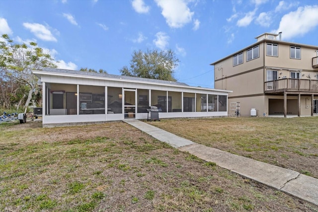 11770 W Sunnybrook Ct, Crystal River, FL 34429 - rear view of house featuring a sunroom and a yard