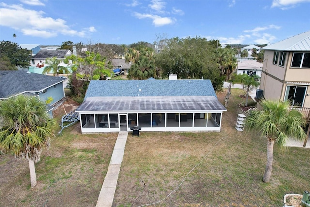 11770 W Sunnybrook Ct, Crystal River, FL 34429 - rear view of house with a sunroom, a residential view, a lawn, and a chimney