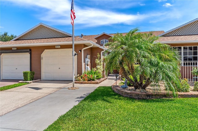 5512 Rosewall Cir, Leesburg, FL 34748 - view of front facade with concrete driveway, a front lawn, an attached garage, and a shingled roof