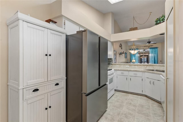 5512 Rosewall Cir, Leesburg, FL 34748 - kitchen featuring white appliances, lofted ceiling, light countertops, and white cabinetry
