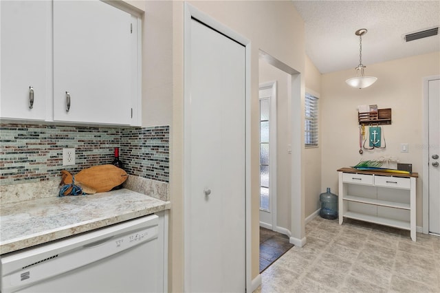 5512 Rosewall Cir, Leesburg, FL 34748 - kitchen featuring dishwasher, decorative backsplash, white cabinets, light countertops, and hanging light fixtures