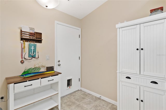 5512 Rosewall Cir, Leesburg, FL 34748 - doorway featuring baseboards and light floors
