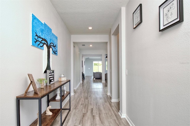 1696 Wilson Prairie Cir, Groveland, FL 34736 - hall with light wood-type flooring, a textured ceiling, and recessed lighting