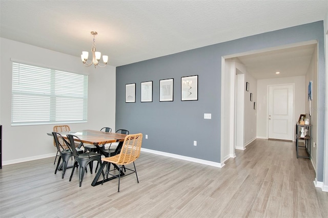 1696 Wilson Prairie Cir, Groveland, FL 34736 - dining area with light wood-style flooring and a chandelier