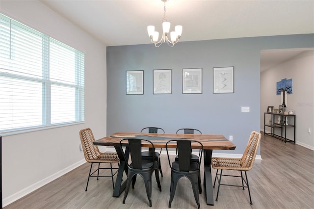 1696 Wilson Prairie Cir, Groveland, FL 34736 - dining area featuring light wood-style flooring and a chandelier