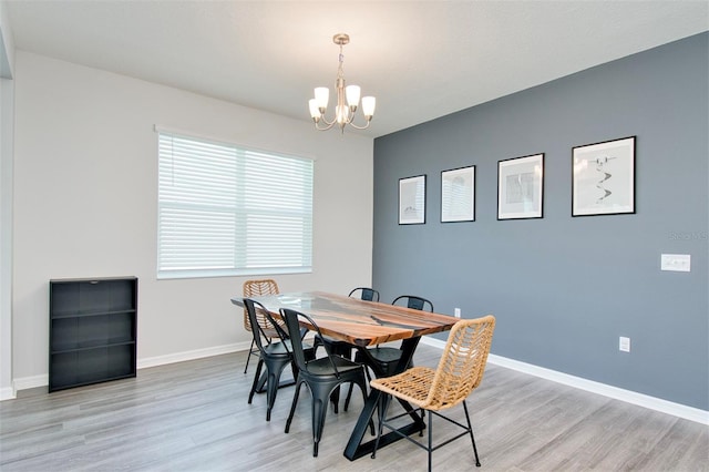 1696 Wilson Prairie Cir, Groveland, FL 34736 - dining room featuring a chandelier and light wood-style floors