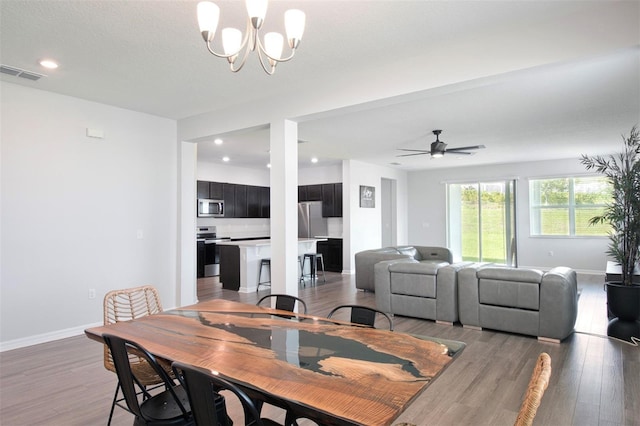 1696 Wilson Prairie Cir, Groveland, FL 34736 - dining room featuring a chandelier, light wood-type flooring, recessed lighting, and ceiling fan