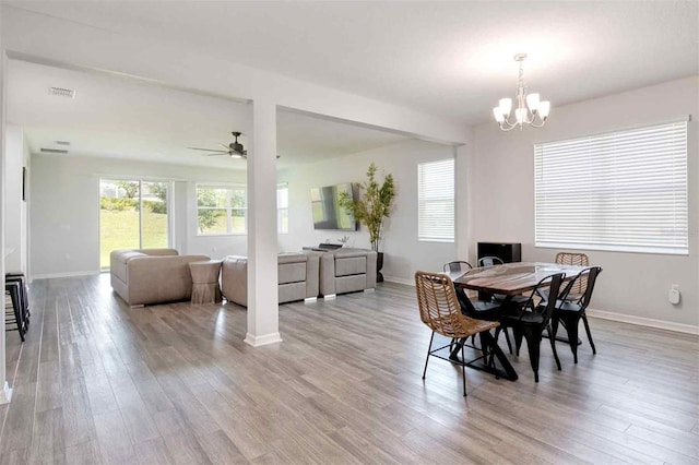 1696 Wilson Prairie Cir, Groveland, FL 34736 - dining room with wood finished floors, a ceiling fan, and a chandelier
