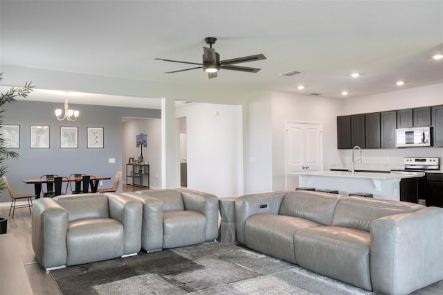 1696 Wilson Prairie Cir, Groveland, FL 34736 - living area featuring ceiling fan, wood finished floors, recessed lighting, and a chandelier